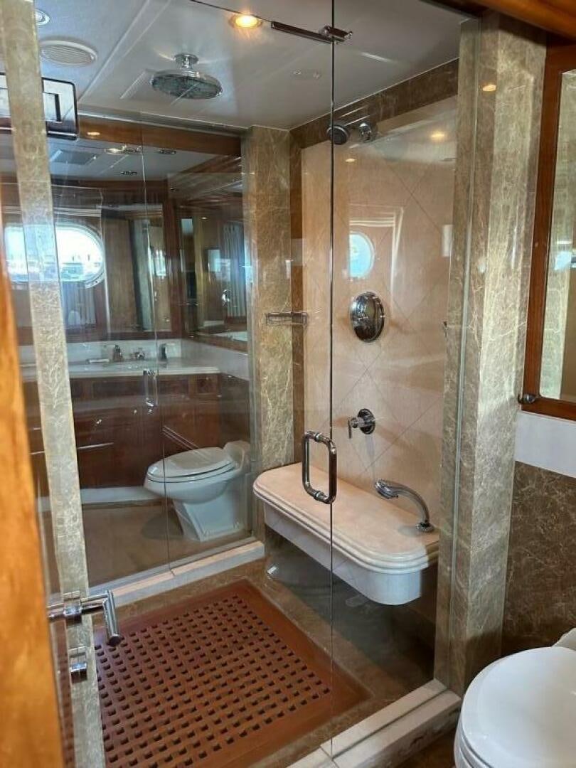 a bathroom with a glass shower aboard MOJITO Yacht for Sale