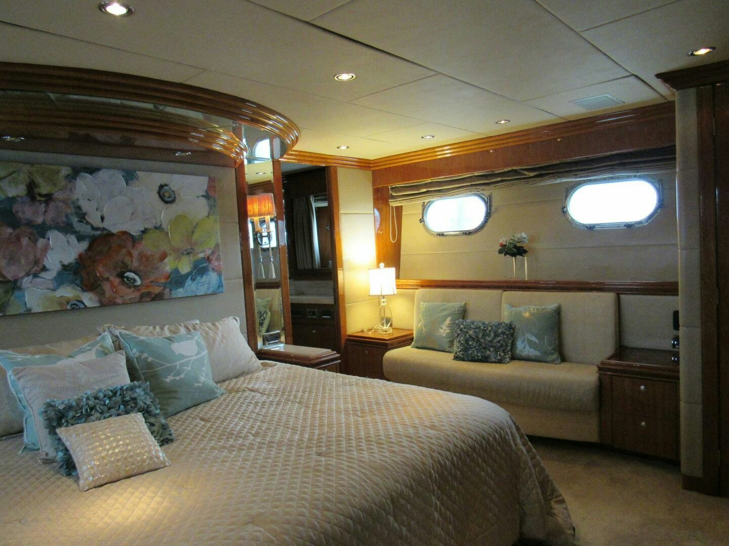 a bedroom with a bed and a painting on the wall aboard MOJITO Yacht for Sale