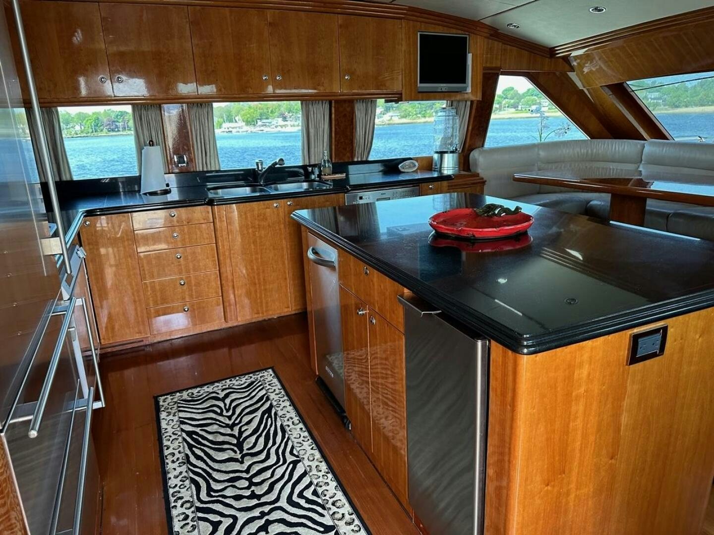 a kitchen with wooden cabinets aboard MOJITO Yacht for Sale