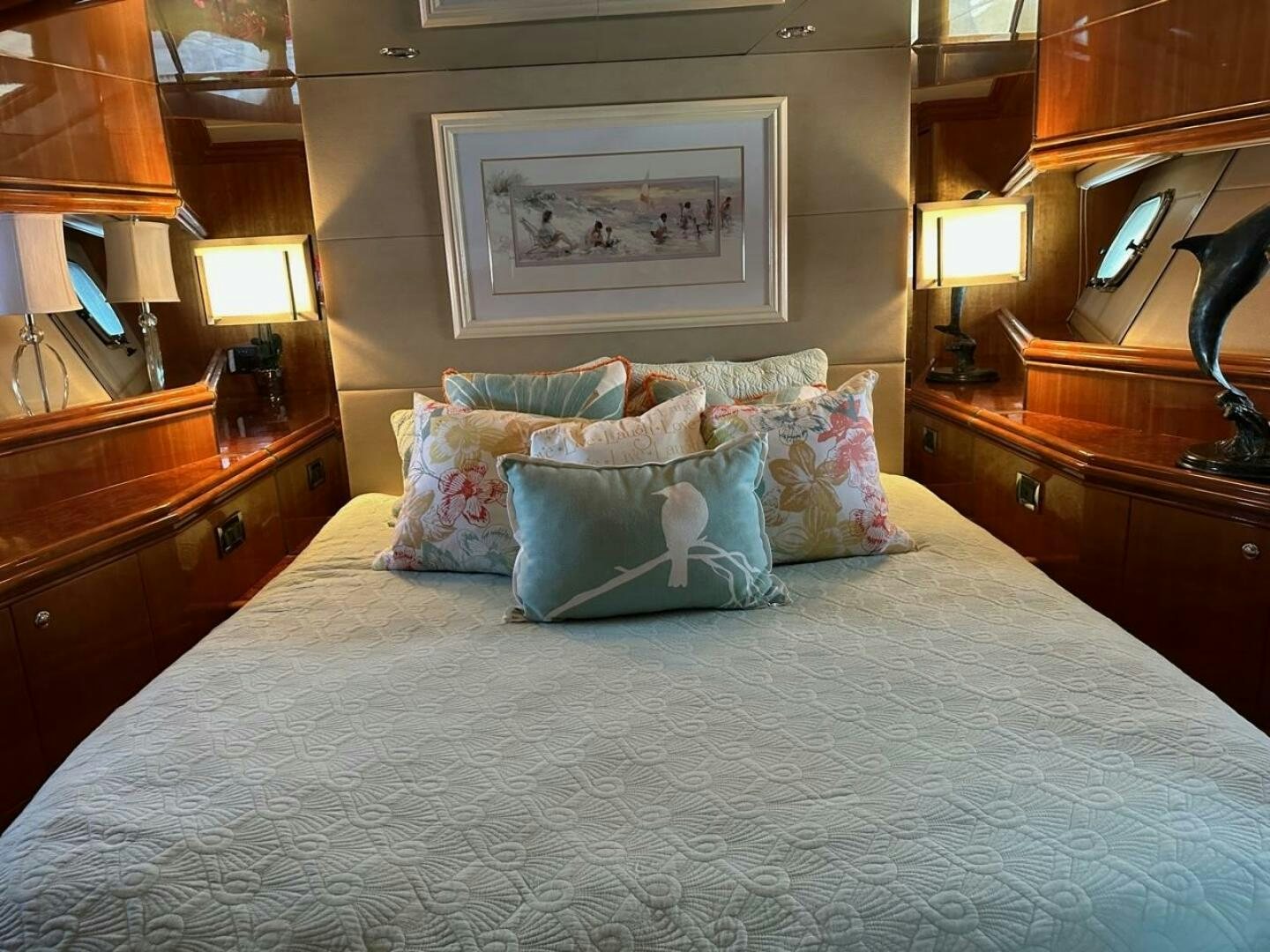 a bed with a blue and white comforter and pillows aboard MOJITO Yacht for Sale