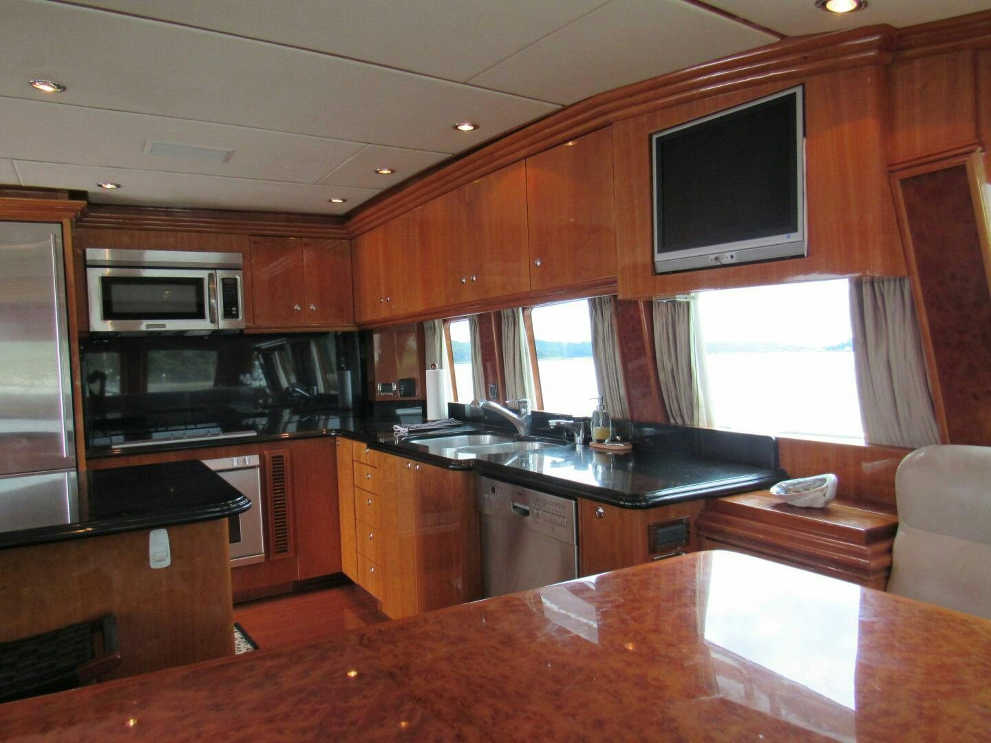 a kitchen with wooden cabinets aboard MOJITO Yacht for Sale