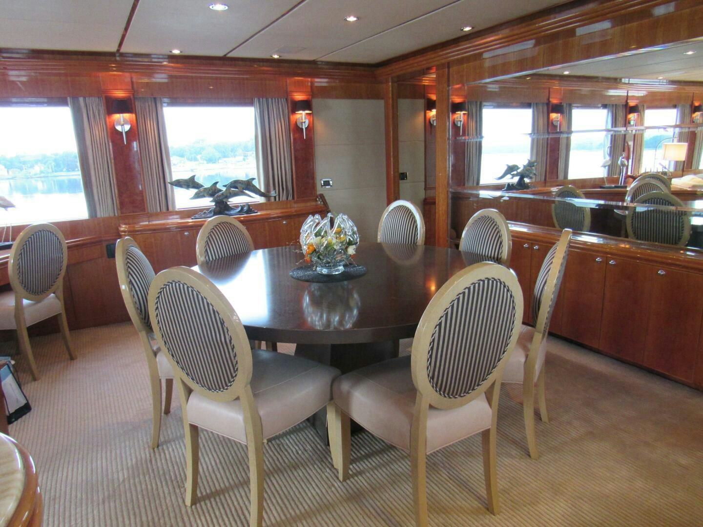 a dining room with a table and chairs aboard MOJITO Yacht for Sale