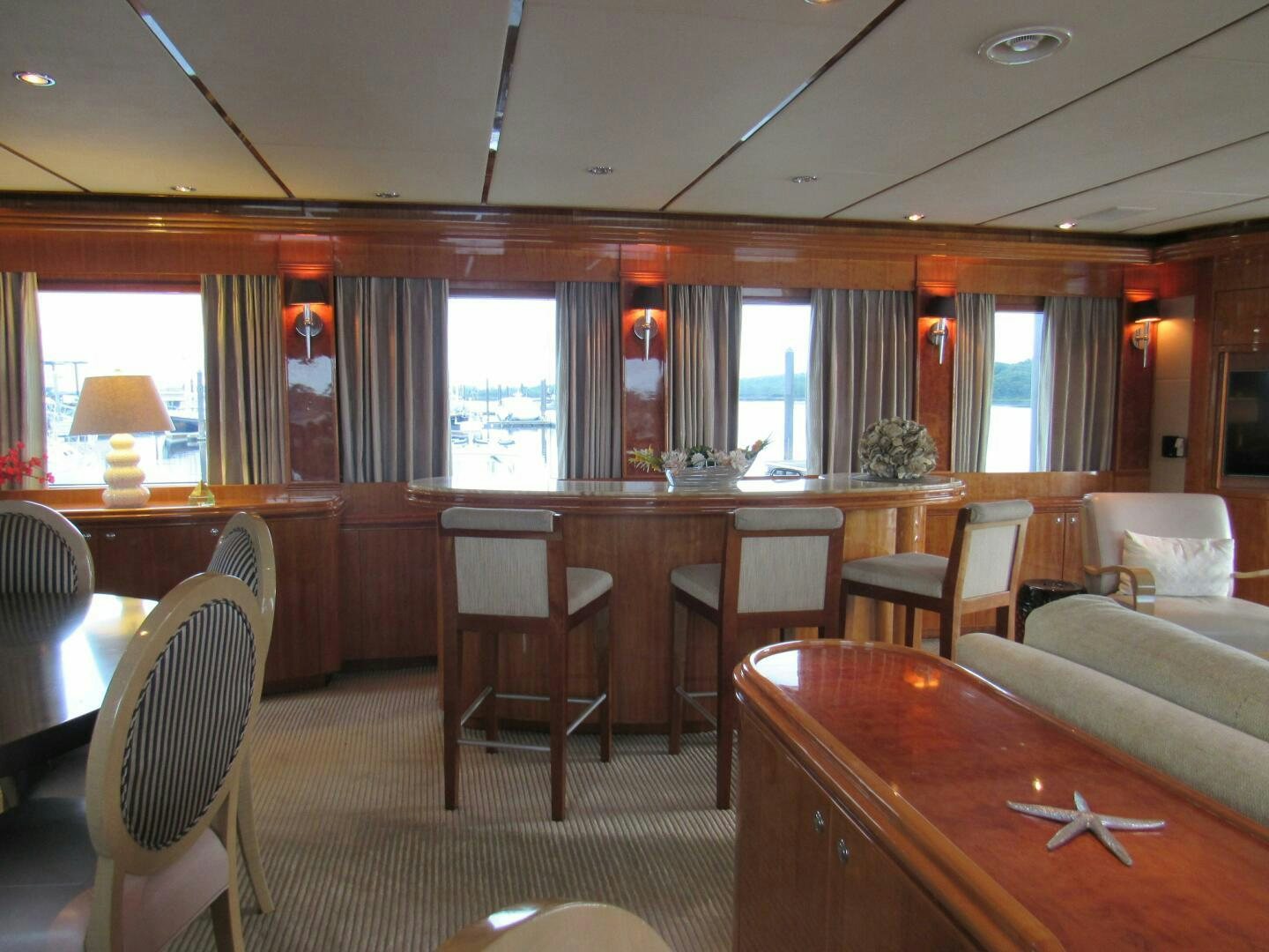 a room with a table chairs and a window aboard MOJITO Yacht for Sale