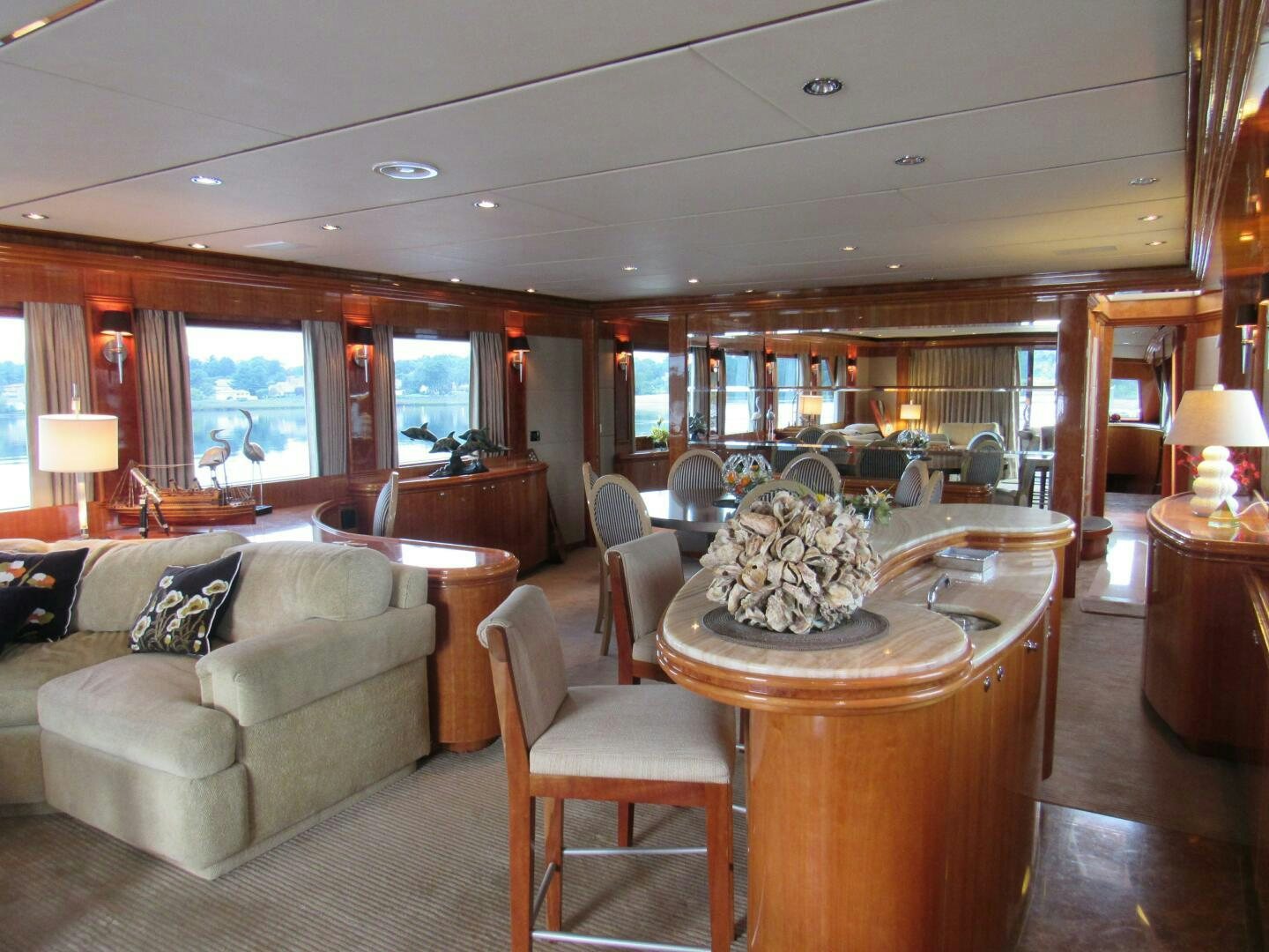 a living room with a large table and chairs aboard MOJITO Yacht for Sale
