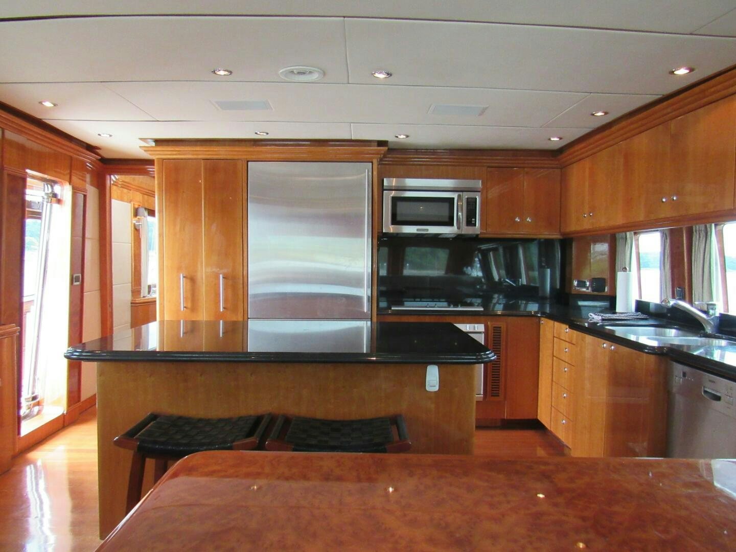 a kitchen with wooden cabinets aboard MOJITO Yacht for Sale