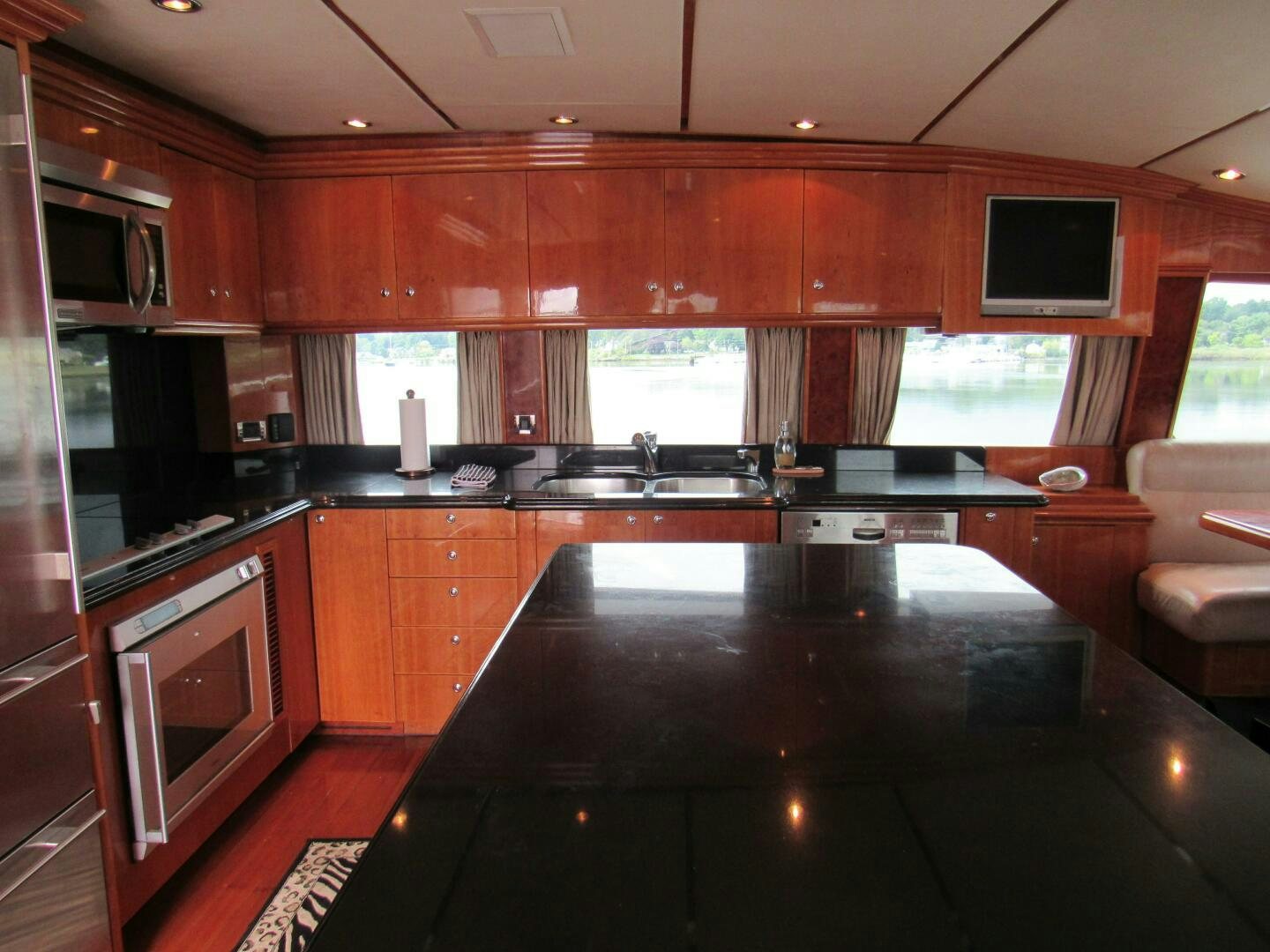 a kitchen with wooden cabinets aboard MOJITO Yacht for Sale
