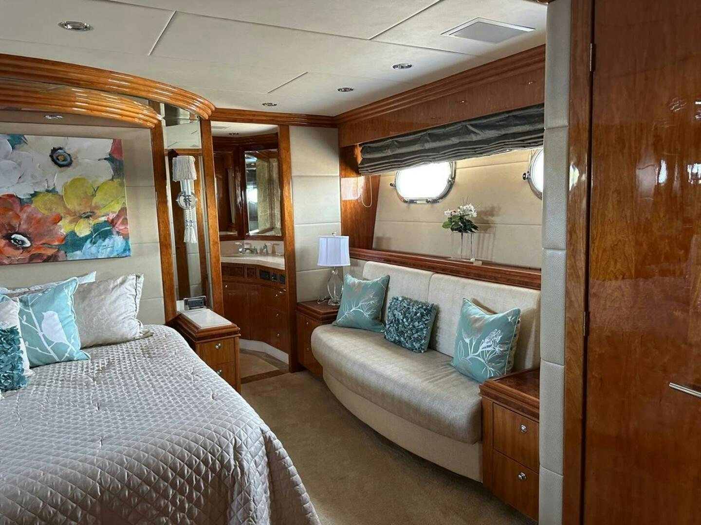 a bedroom with a bed and a mirror aboard MOJITO Yacht for Sale