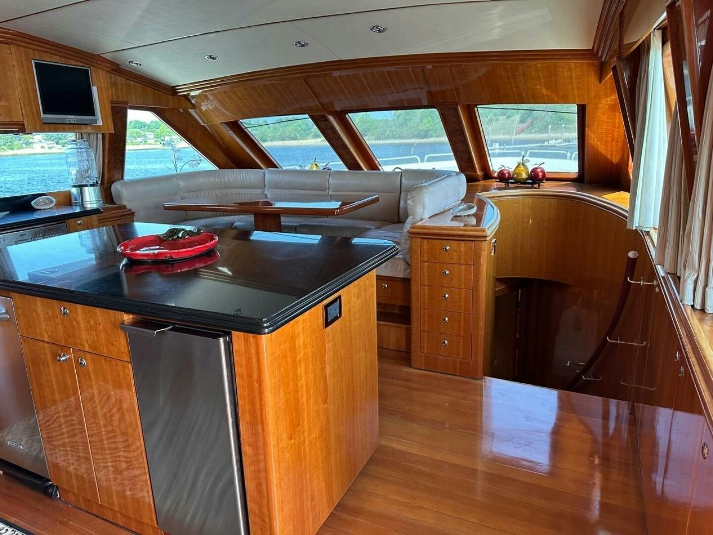 a kitchen with a large wooden table aboard MOJITO Yacht for Sale