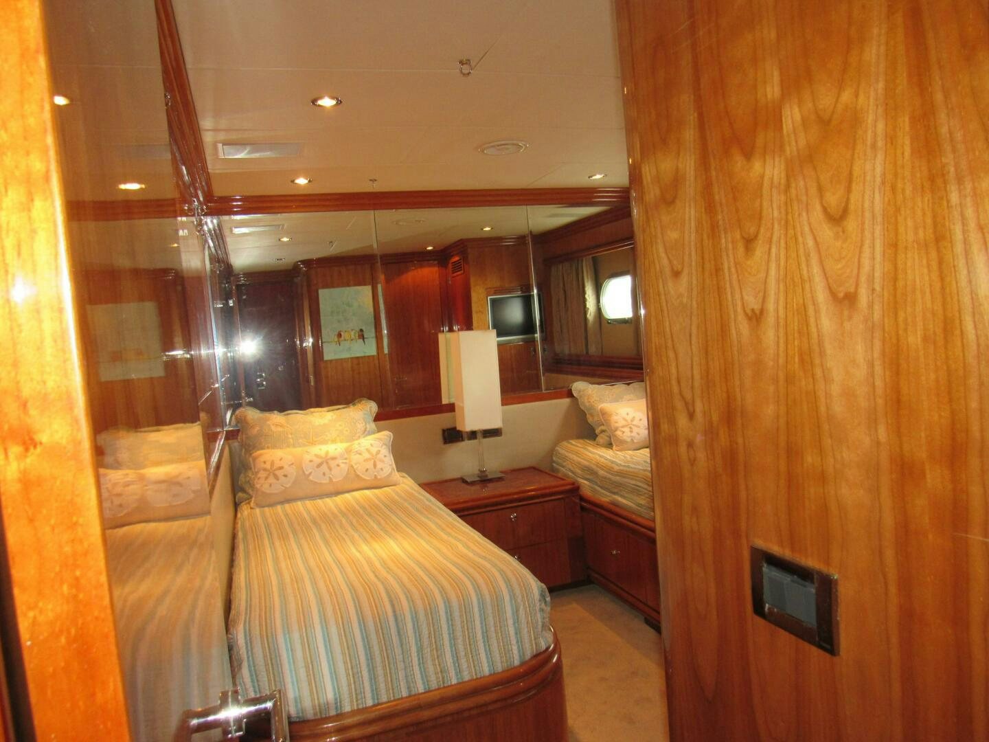 a room with a bed and a lamp aboard MOJITO Yacht for Sale