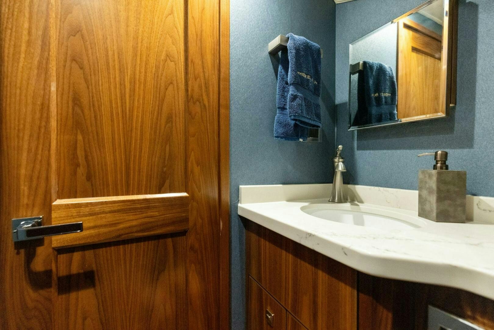 a bathroom with a sink and mirror aboard WHISKEY PAPA Yacht for Sale