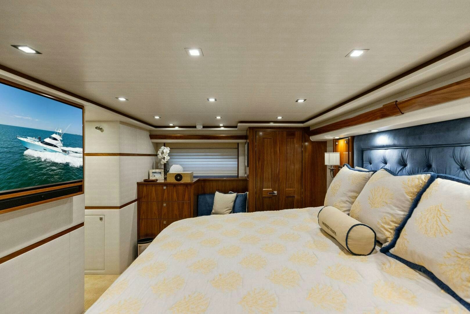 a bedroom with a large television aboard WHISKEY PAPA Yacht for Sale