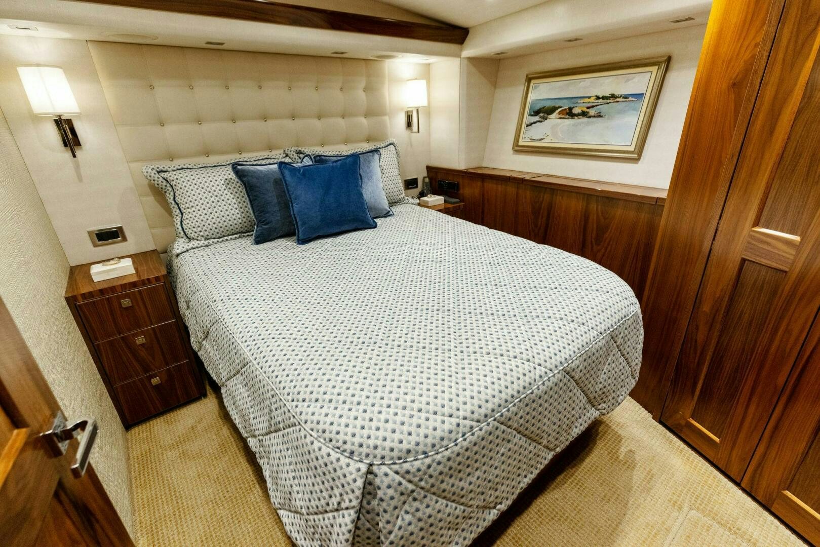 a bed with blue and white sheets aboard WHISKEY PAPA Yacht for Sale