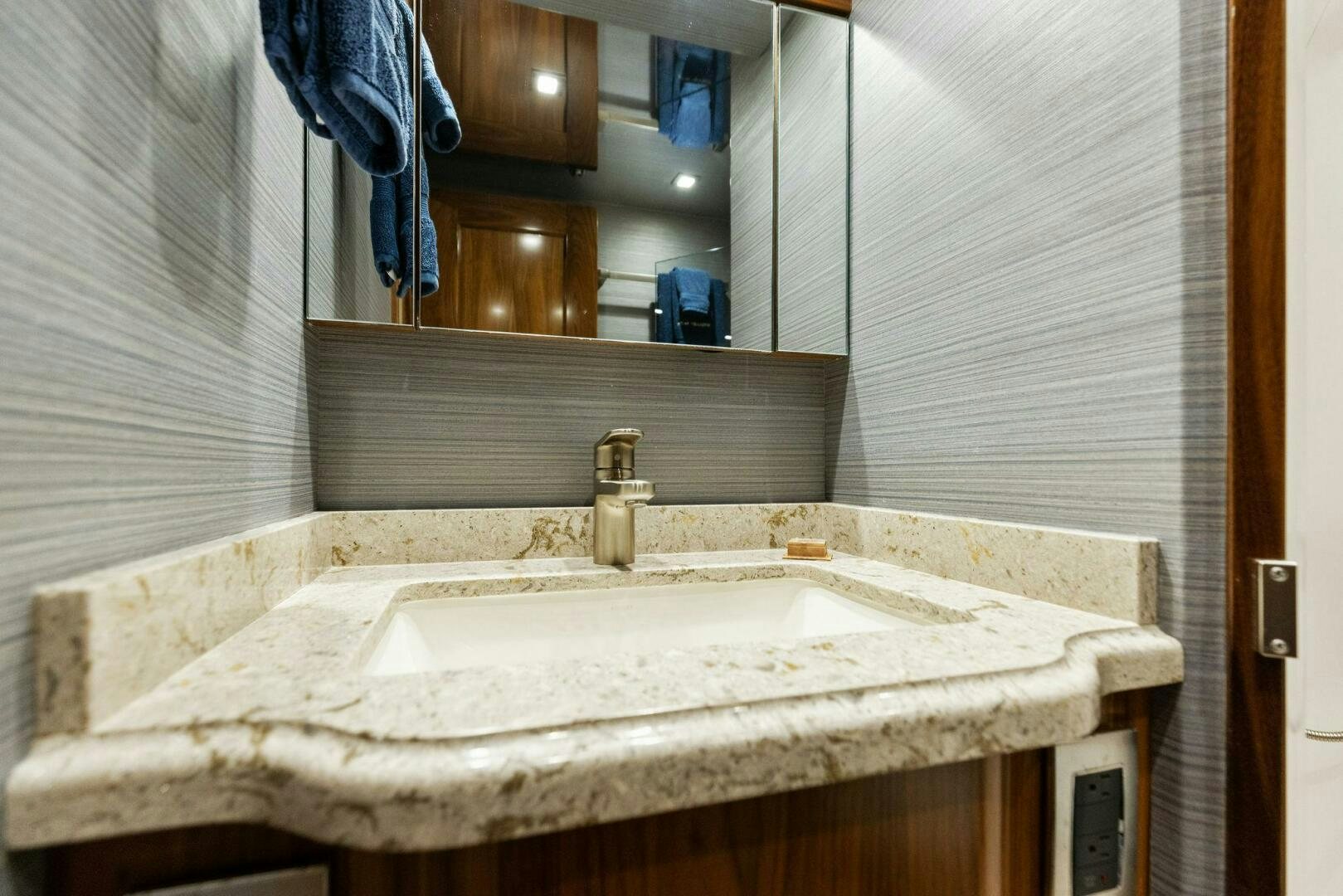 a bathroom with a sink and mirror aboard WHISKEY PAPA Yacht for Sale