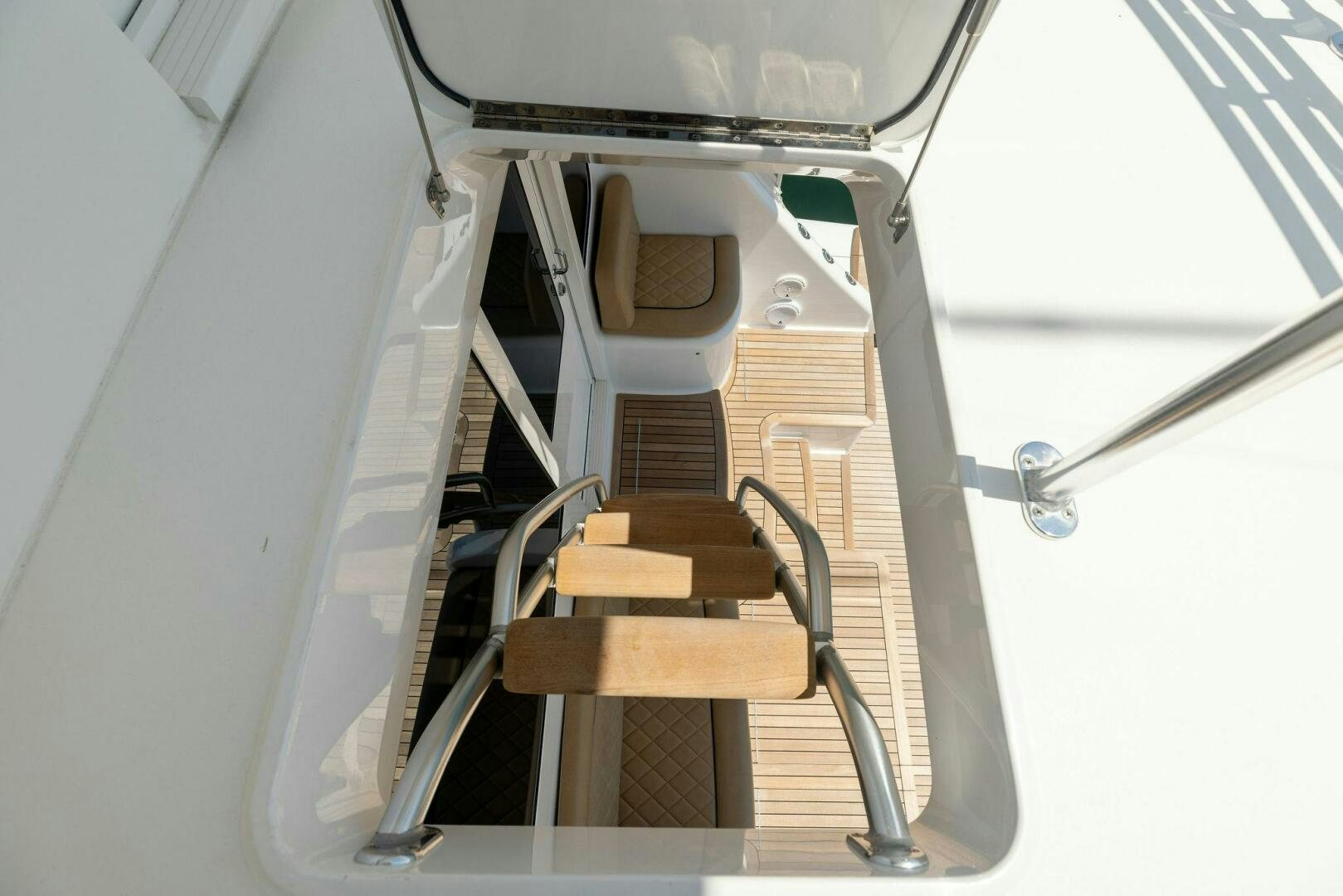 a wooden chair on a metal stand aboard WHISKEY PAPA Yacht for Sale