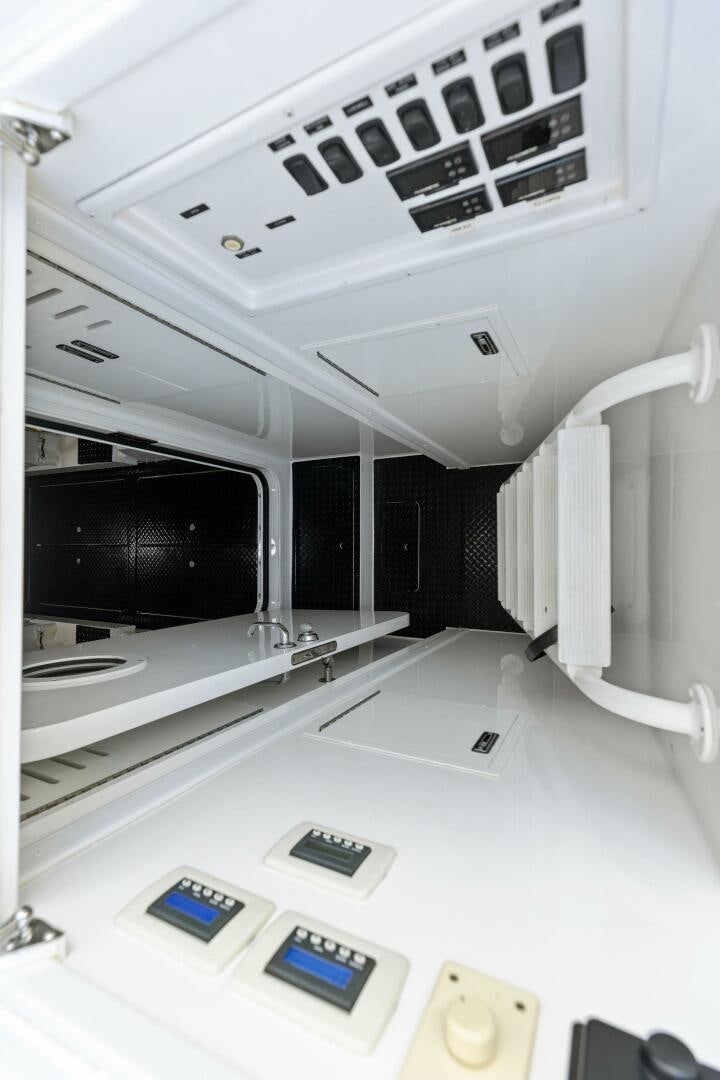 a room with a large white table and a computer monitor aboard WHISKEY PAPA Yacht for Sale