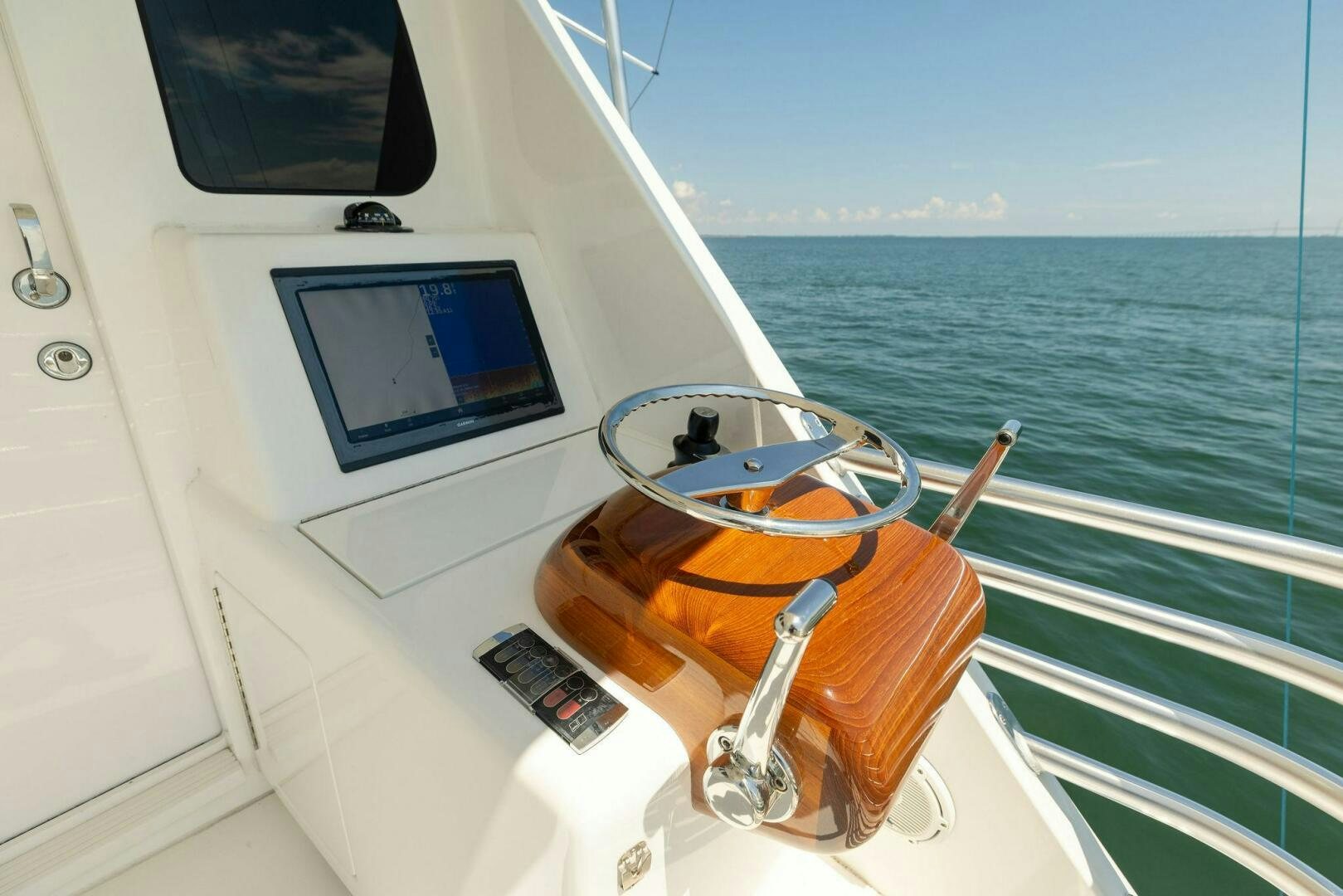 a boat with a steering wheel and a screen on the back aboard WHISKEY PAPA Yacht for Sale