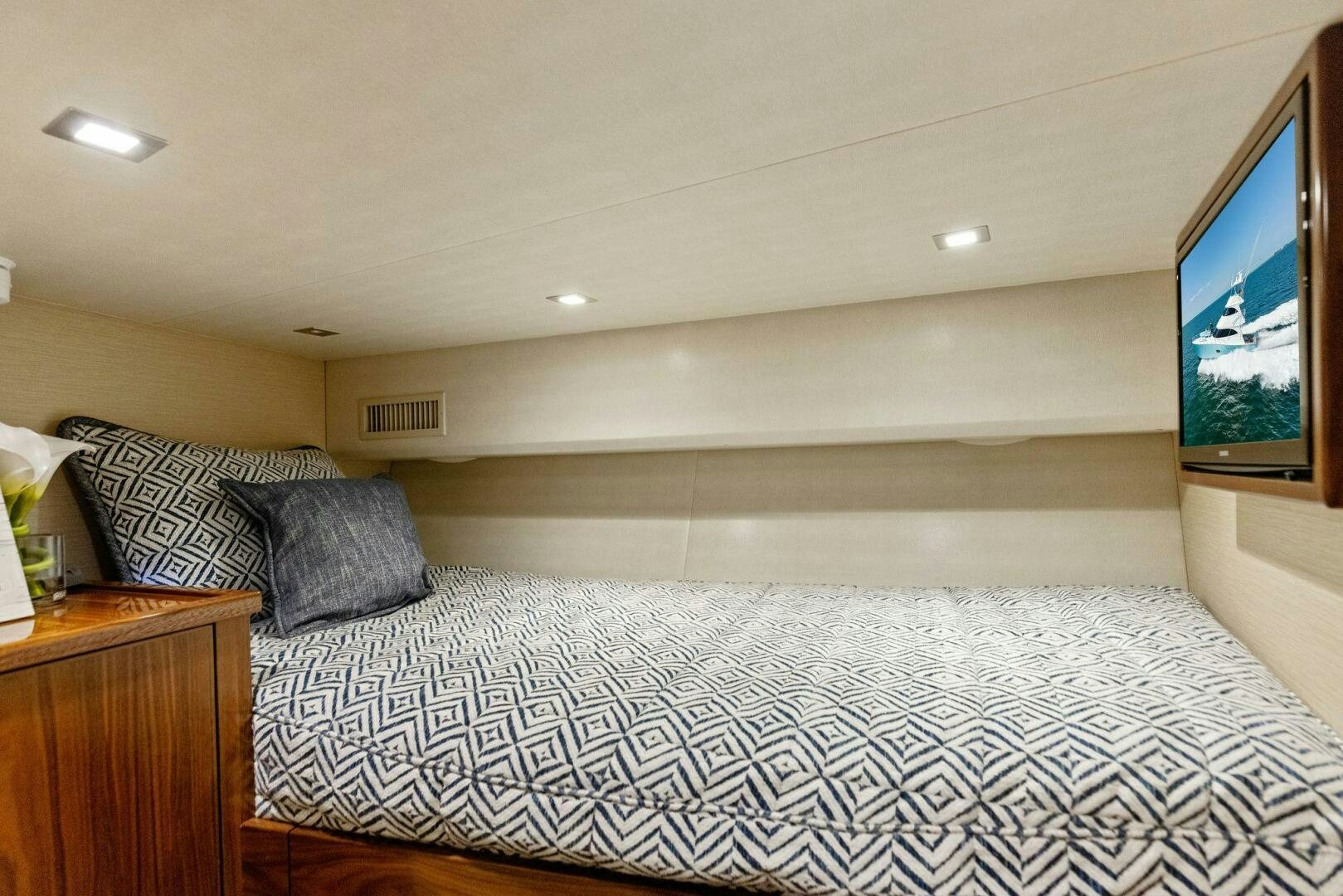 a bed with a television on the wall aboard WHISKEY PAPA Yacht for Sale