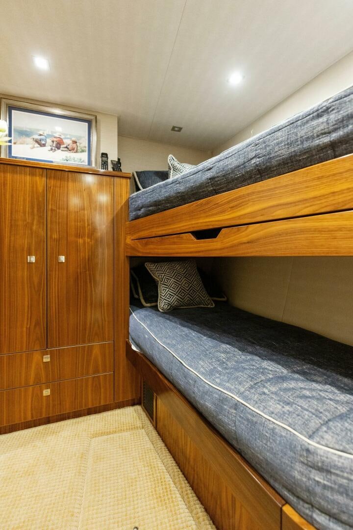 a bed with a wooden headboard aboard WHISKEY PAPA Yacht for Sale