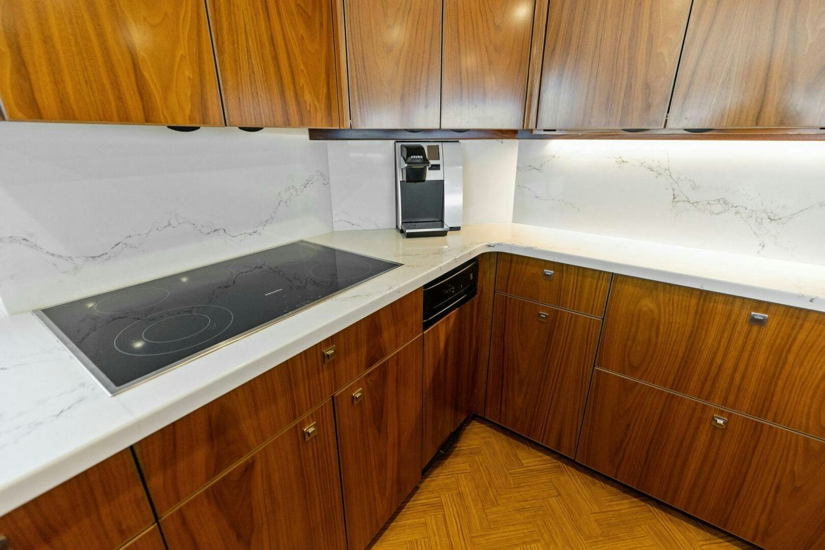 a kitchen with wooden cabinets aboard WHISKEY PAPA Yacht for Sale