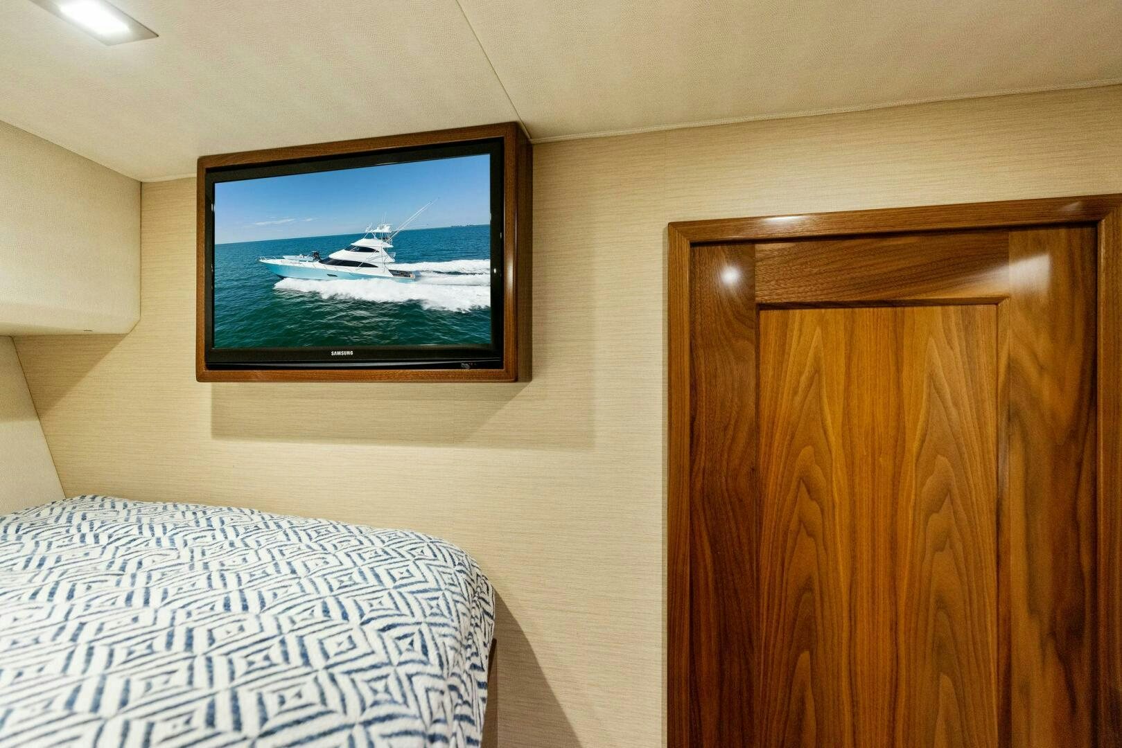 a television on a wall above a bed aboard WHISKEY PAPA Yacht for Sale
