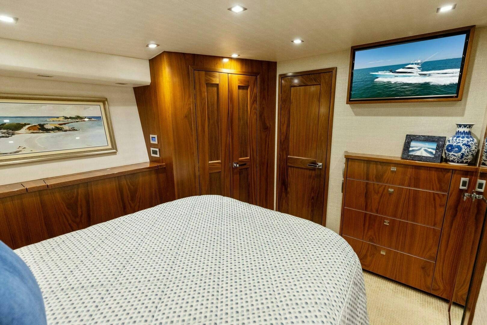 a bedroom with a bed and a television on the wall aboard WHISKEY PAPA Yacht for Sale