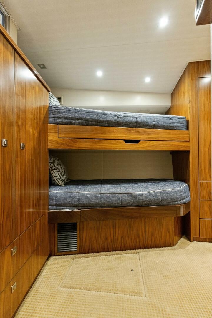 a bed with a wooden headboard aboard WHISKEY PAPA Yacht for Sale