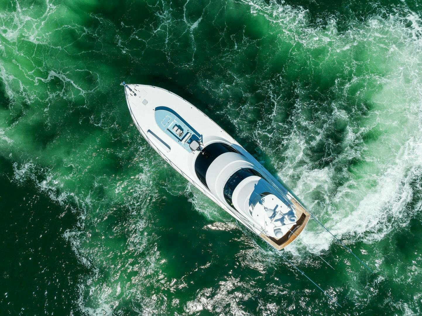 a white surfboard on a wave aboard WHISKEY PAPA Yacht for Sale