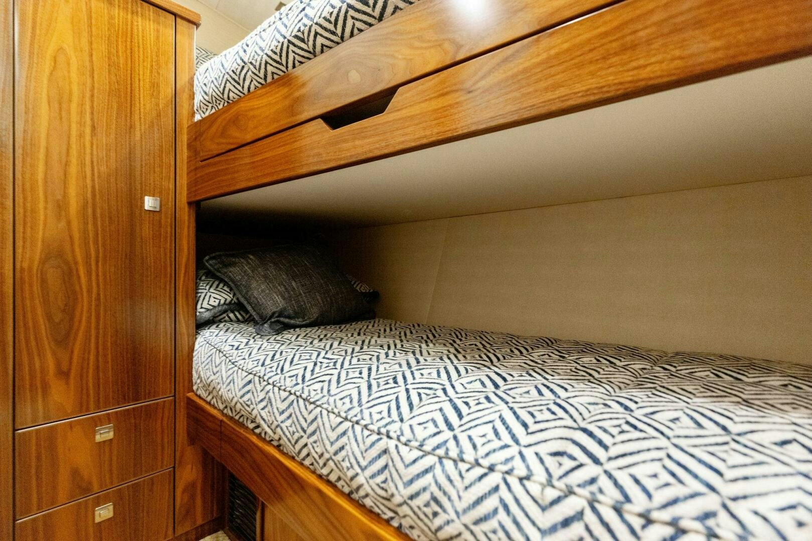 a bed with a wooden headboard aboard WHISKEY PAPA Yacht for Sale