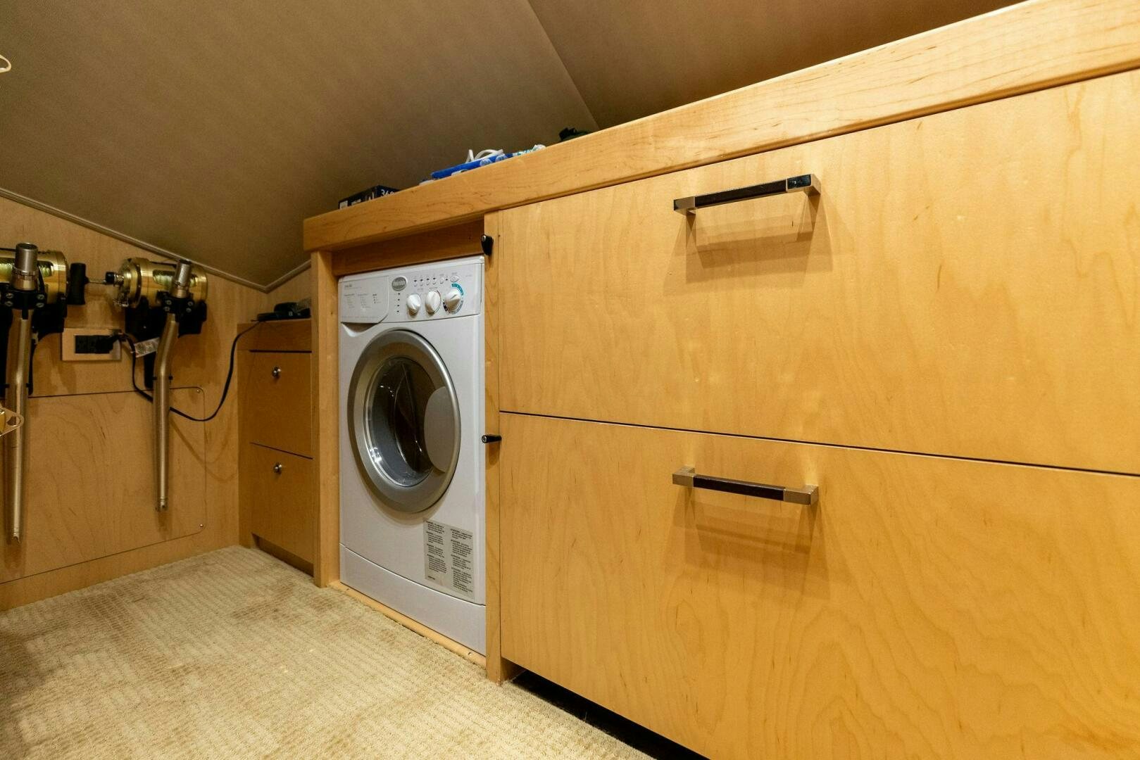a white washing machine in a room aboard WHISKEY PAPA Yacht for Sale
