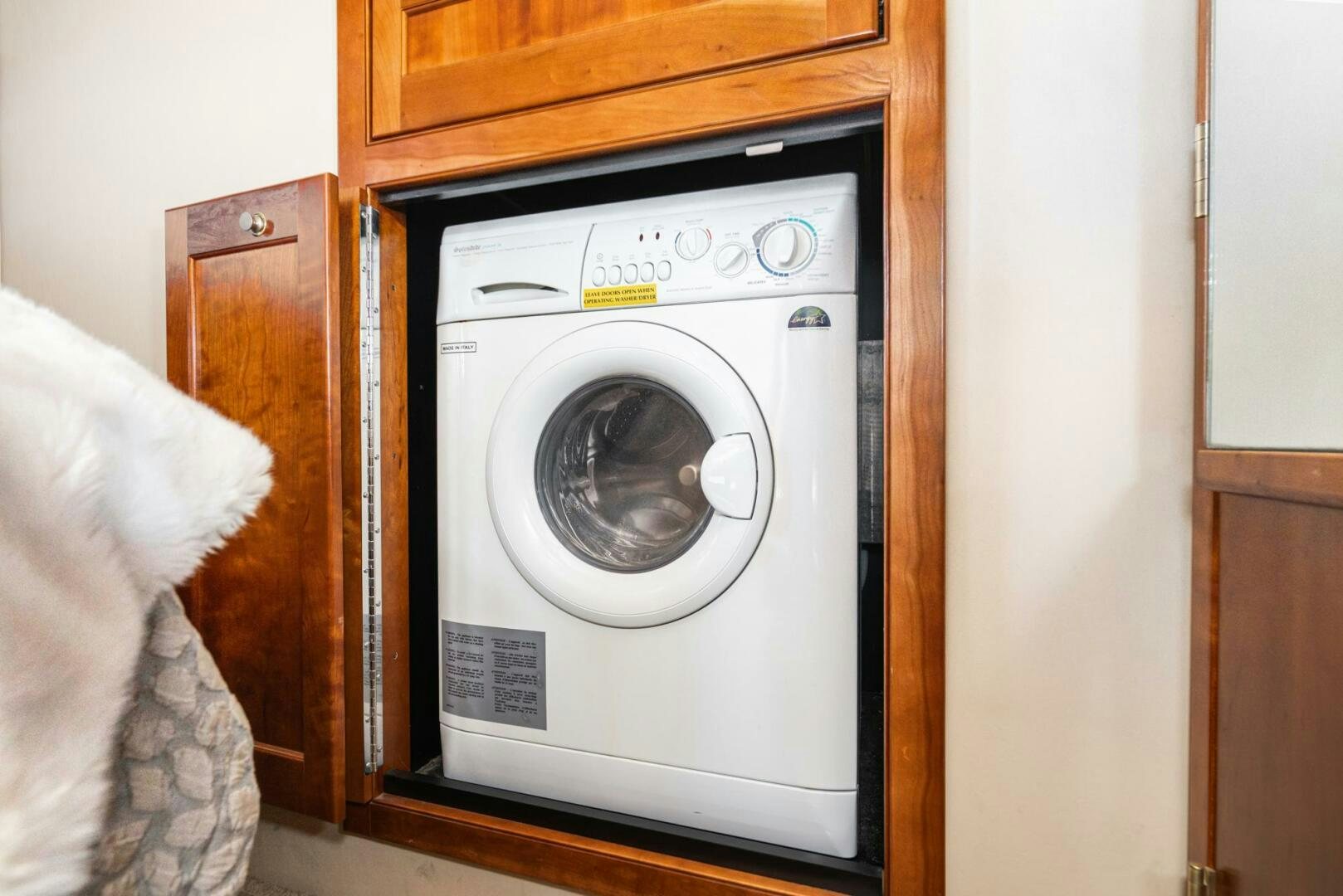 a white washing machine aboard MYSTIQUE Yacht for Sale