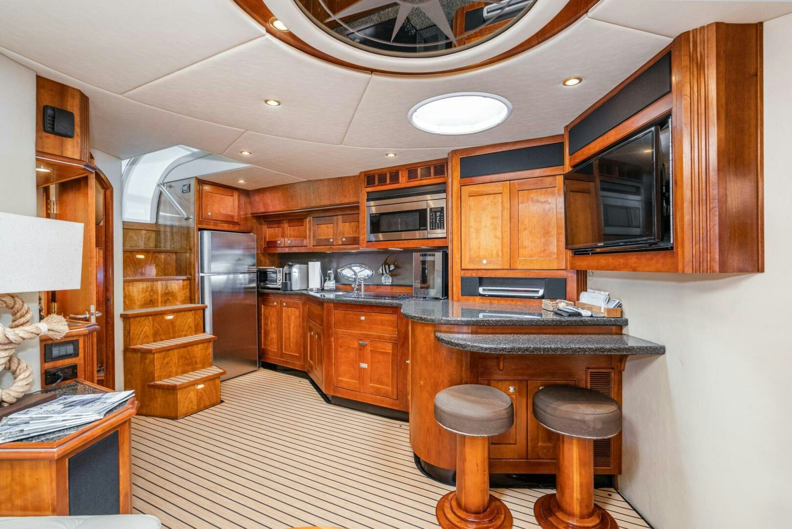 a kitchen with wooden cabinets aboard MYSTIQUE Yacht for Sale