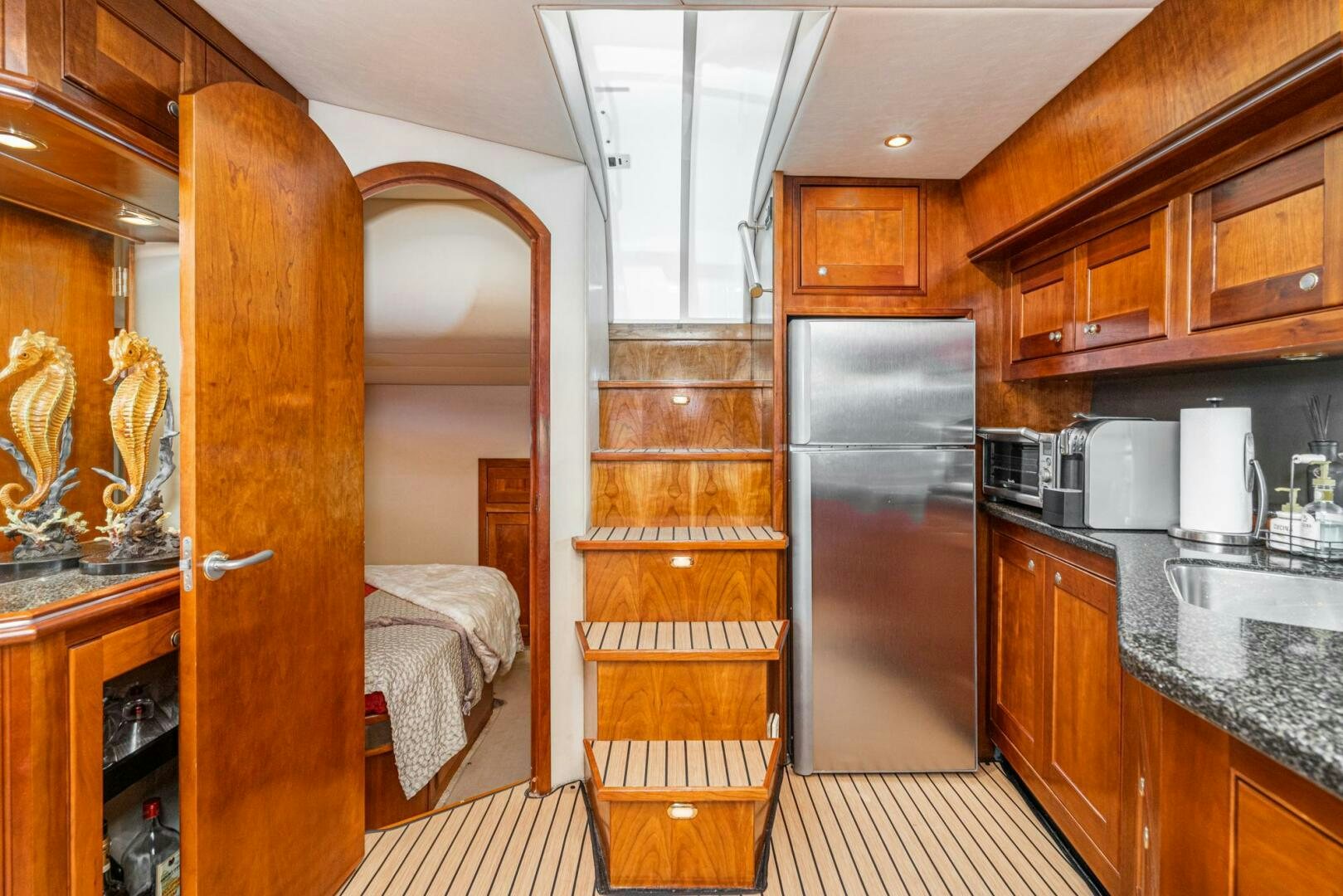 a kitchen with wooden cabinets aboard MYSTIQUE Yacht for Sale