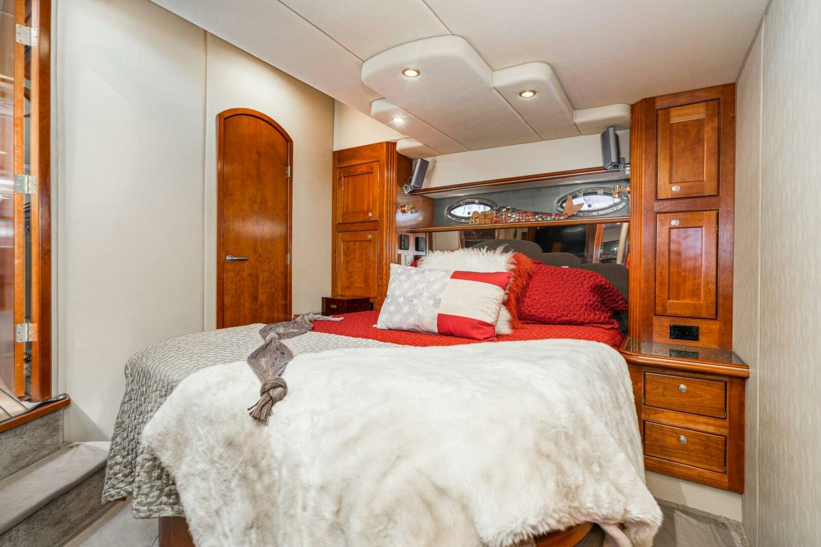 a bedroom with a bed and a dresser aboard MYSTIQUE Yacht for Sale