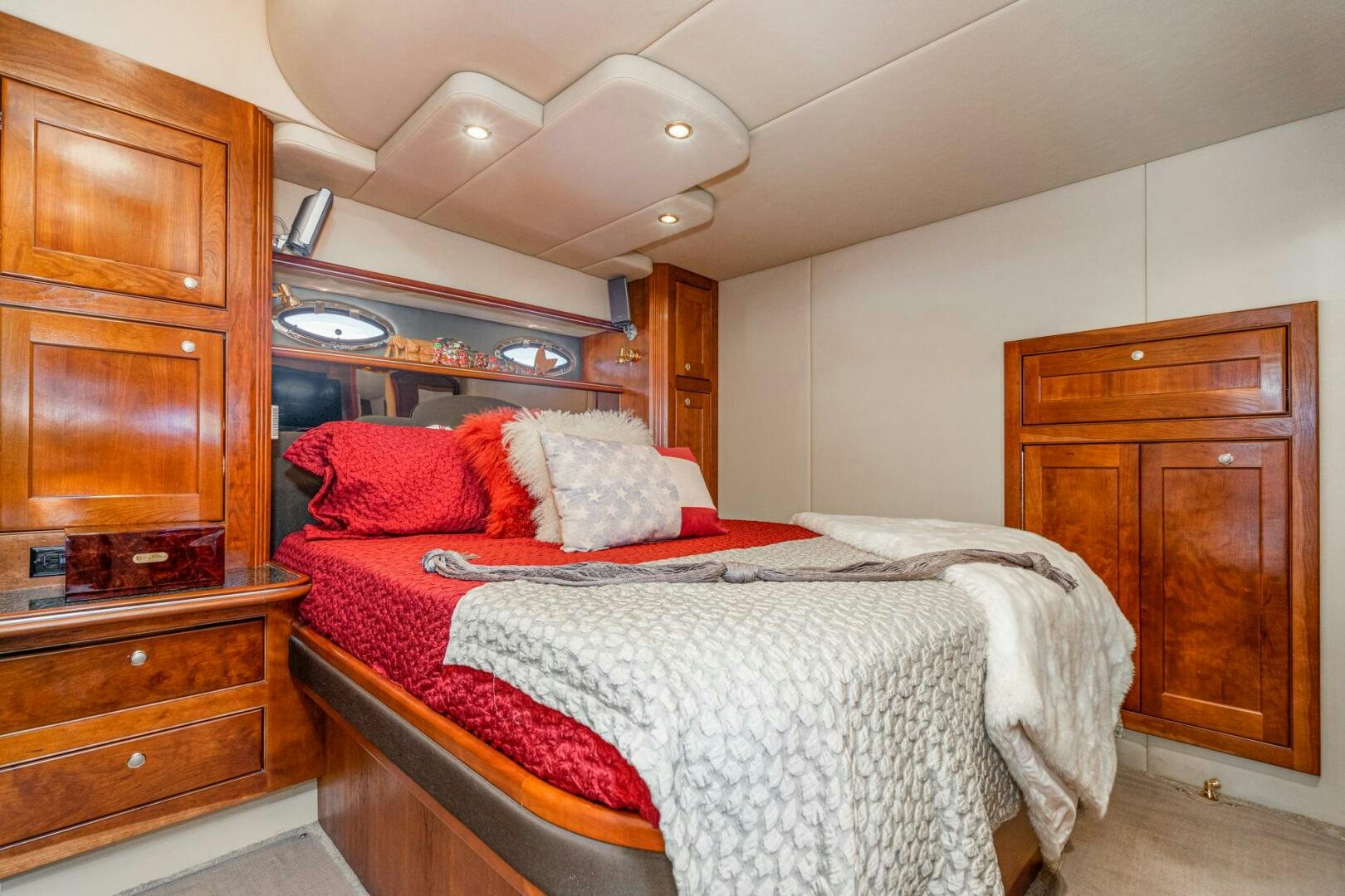 a bedroom with a bed and a dresser aboard MYSTIQUE Yacht for Sale
