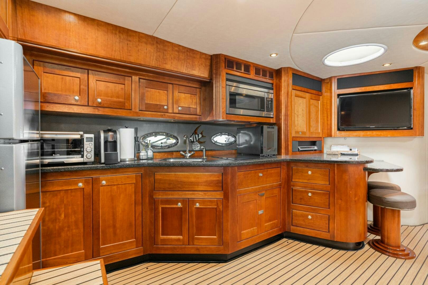 a kitchen with wooden cabinets aboard MYSTIQUE Yacht for Sale