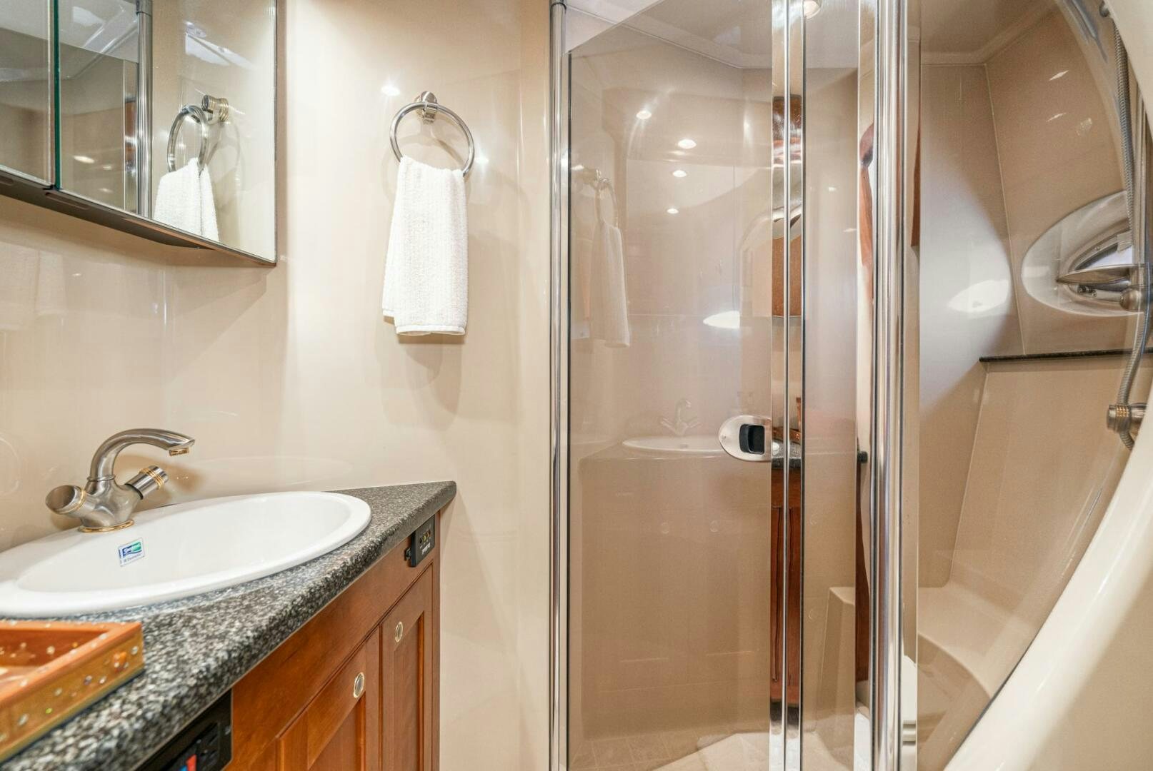 a bathroom with a glass shower aboard MYSTIQUE Yacht for Sale