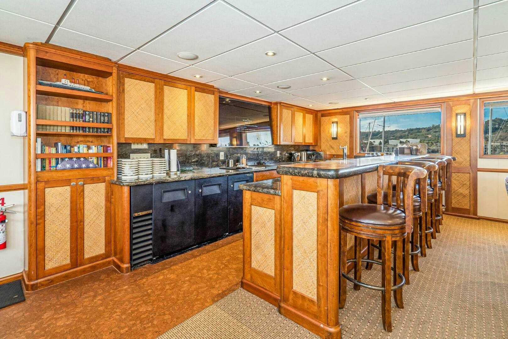 a kitchen with wooden cabinets aboard PACIFIC PROVIDER Yacht for Sale