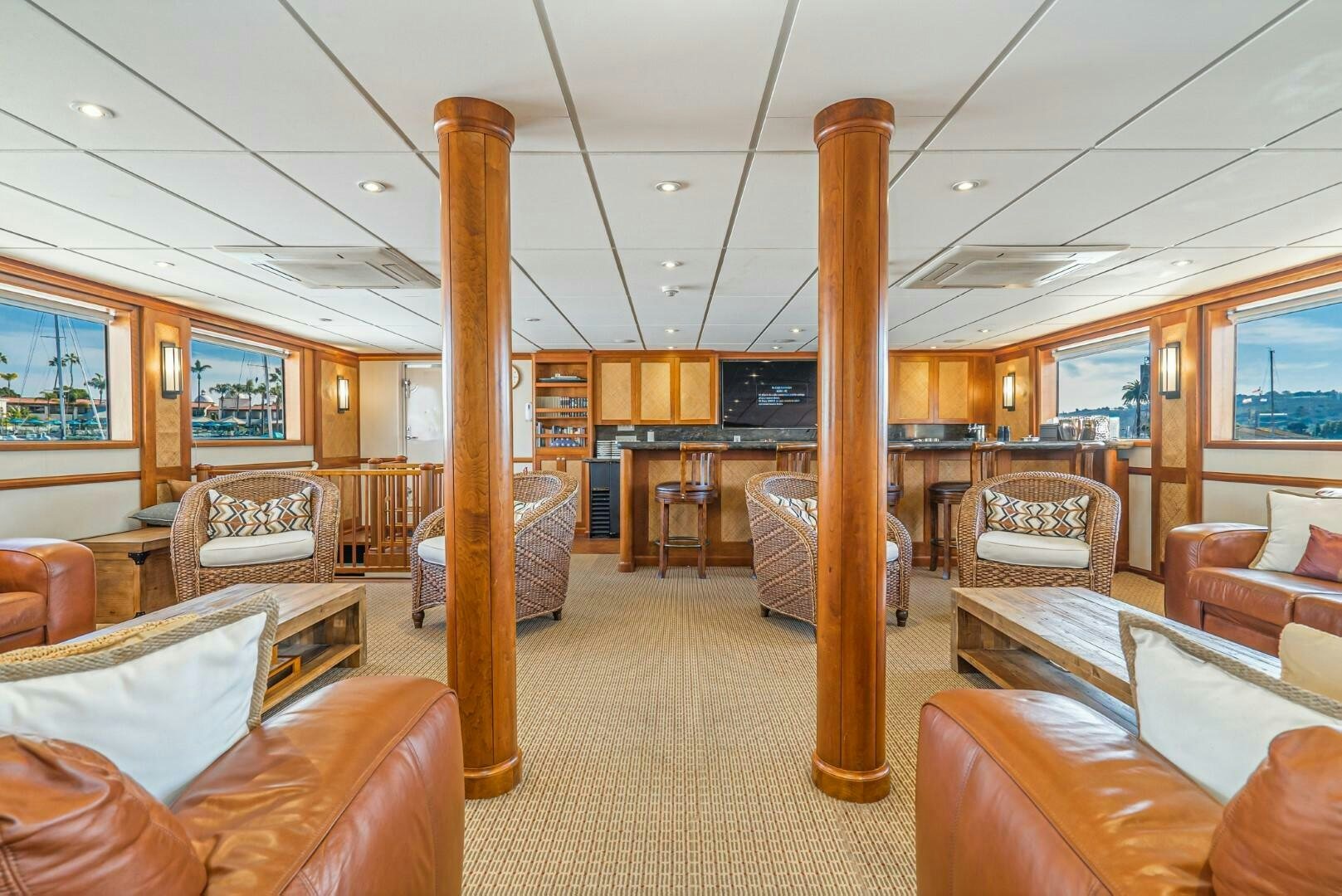 a large room with couches and chairs aboard PACIFIC PROVIDER Yacht for Sale