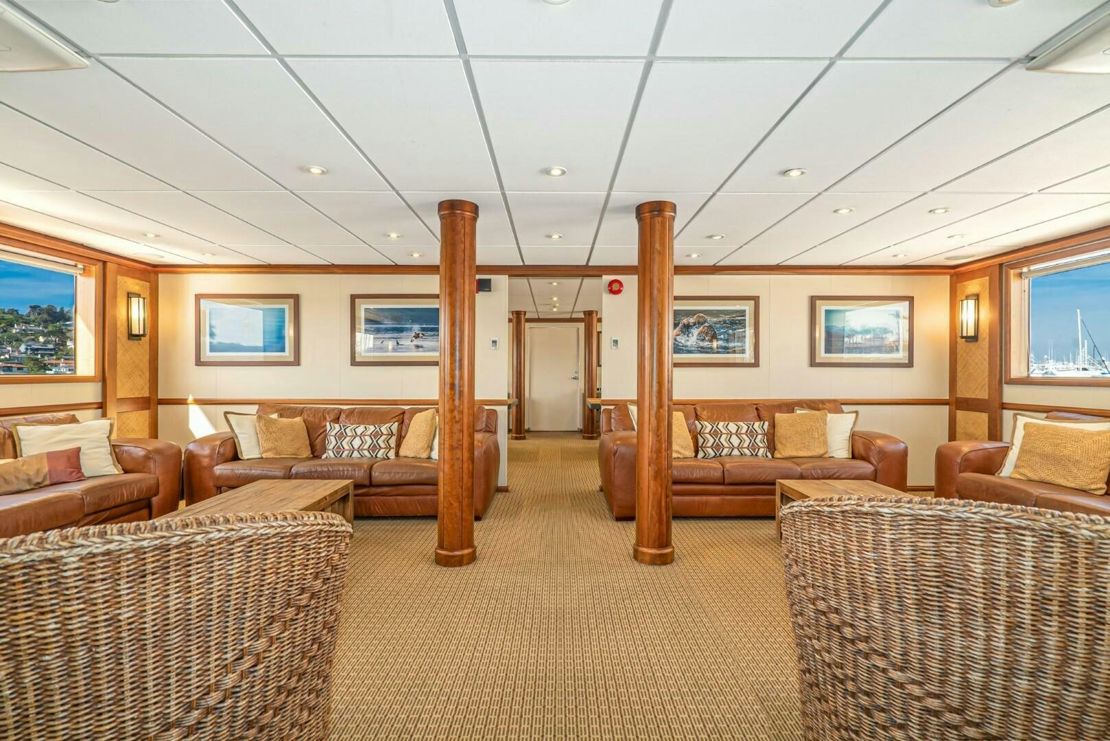 a large living room with a wood floor and a wood door aboard PACIFIC PROVIDER Yacht for Sale