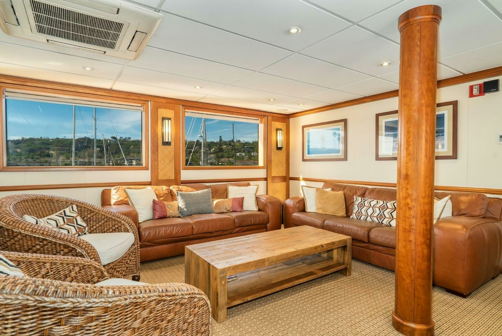 a living room with couches and a table aboard PACIFIC PROVIDER Yacht for Sale