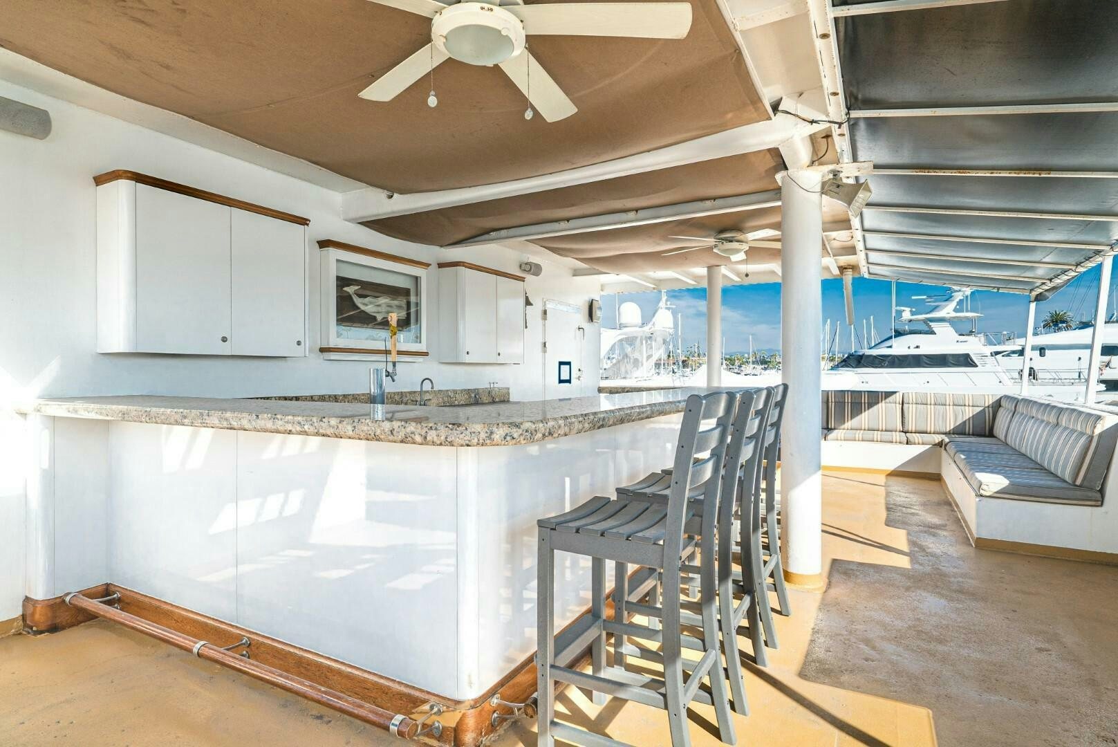 a large room with a chair and a table and a couch aboard PACIFIC PROVIDER Yacht for Sale