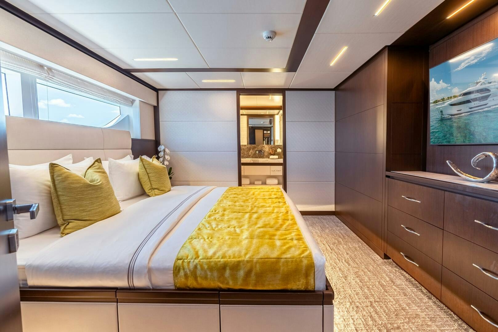 a bedroom with a bed and a tv aboard ROMEO FOXTROT Yacht for Sale