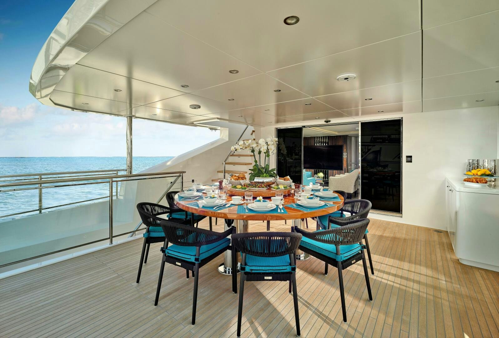 a table and chairs on a deck aboard ROMEO FOXTROT Yacht for Sale