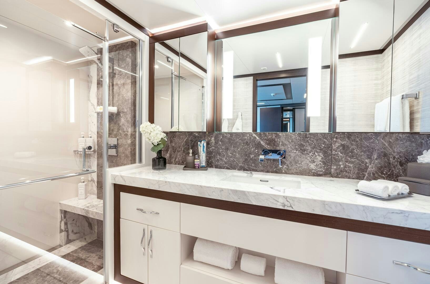 a bathroom with a large mirror aboard ROMEO FOXTROT Yacht for Sale
