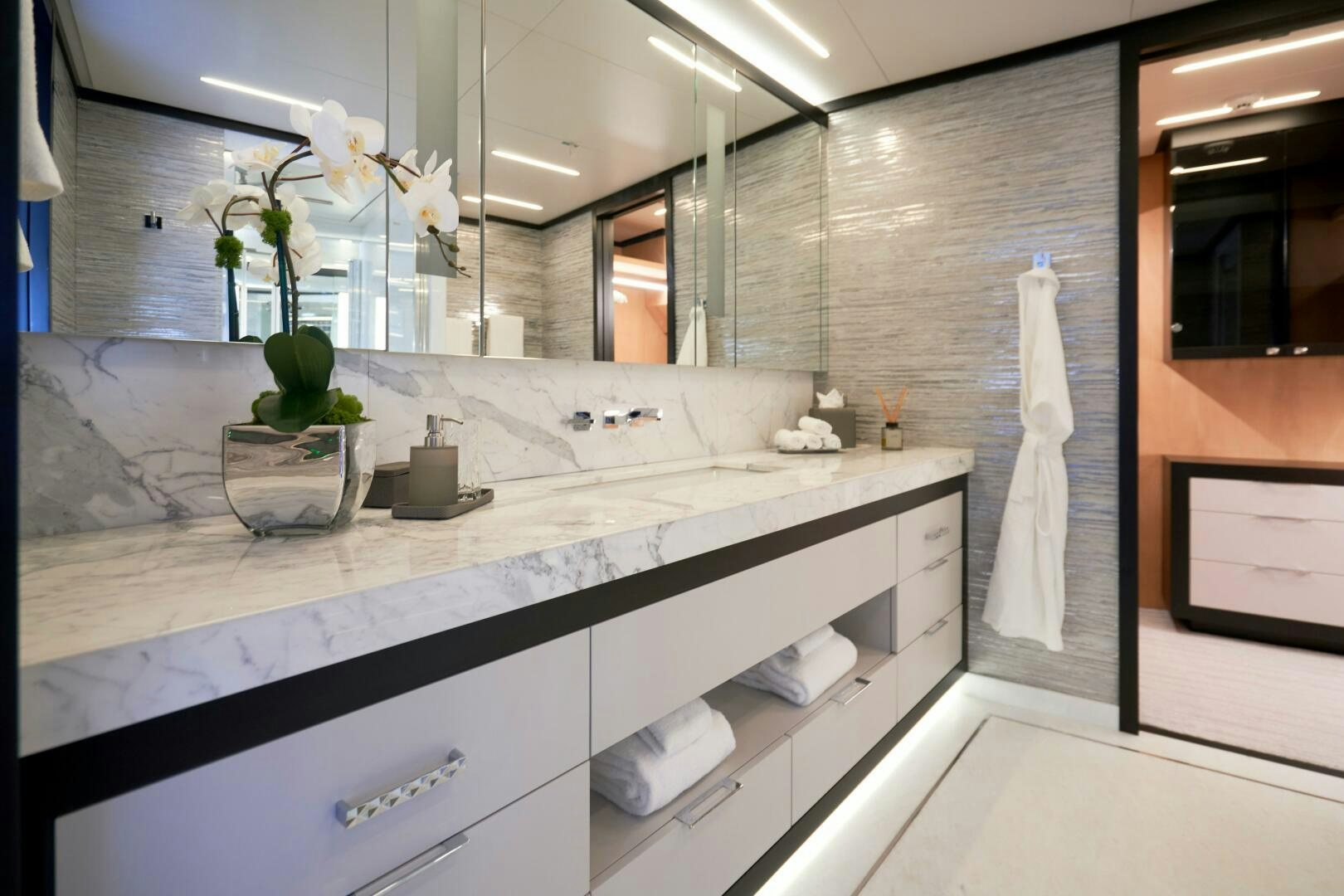 a bathroom with a large mirror aboard ROMEO FOXTROT Yacht for Sale