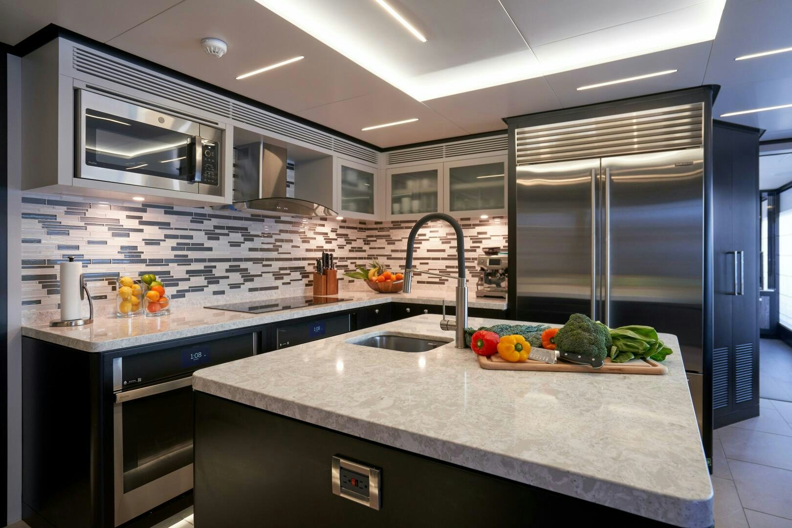 a kitchen with a large island aboard ROMEO FOXTROT Yacht for Sale