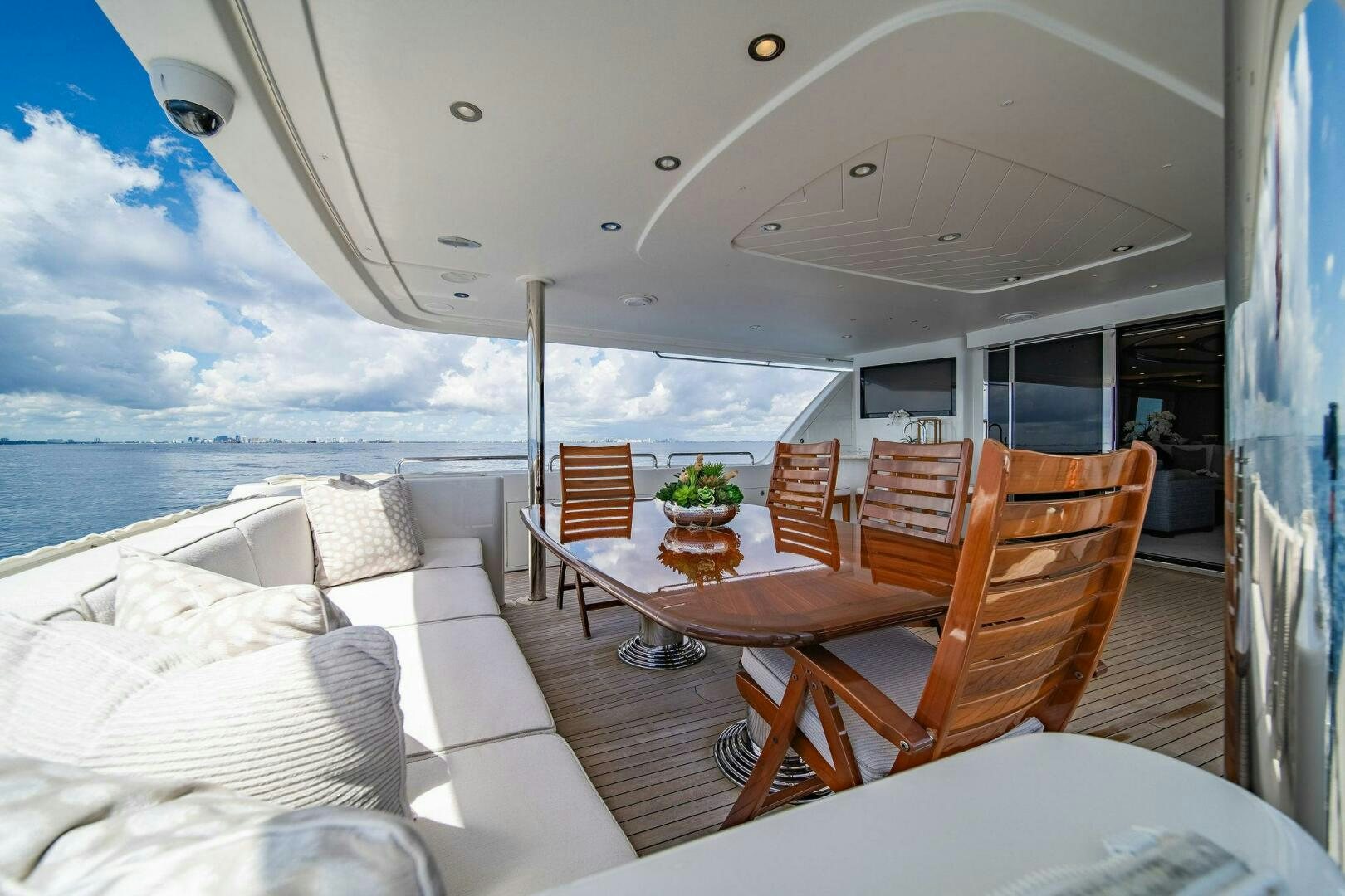 a room with a table chairs and a view of the ocean aboard JEANNIETINI NAME RESERVED Yacht for Sale