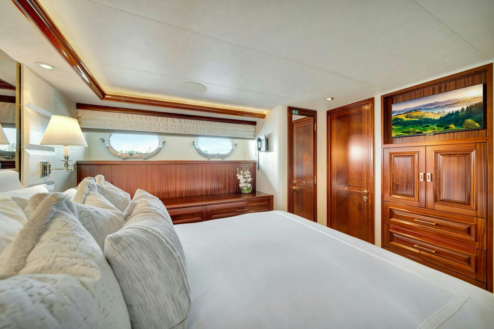 a bedroom with a bed and a dresser aboard JEANNIETINI NAME RESERVED Yacht for Sale