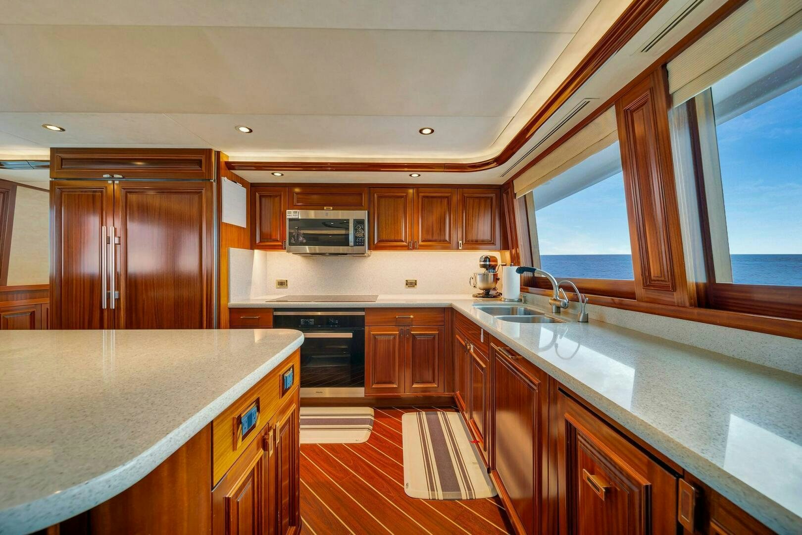 a kitchen with wooden cabinets aboard JEANNIETINI NAME RESERVED Yacht for Sale