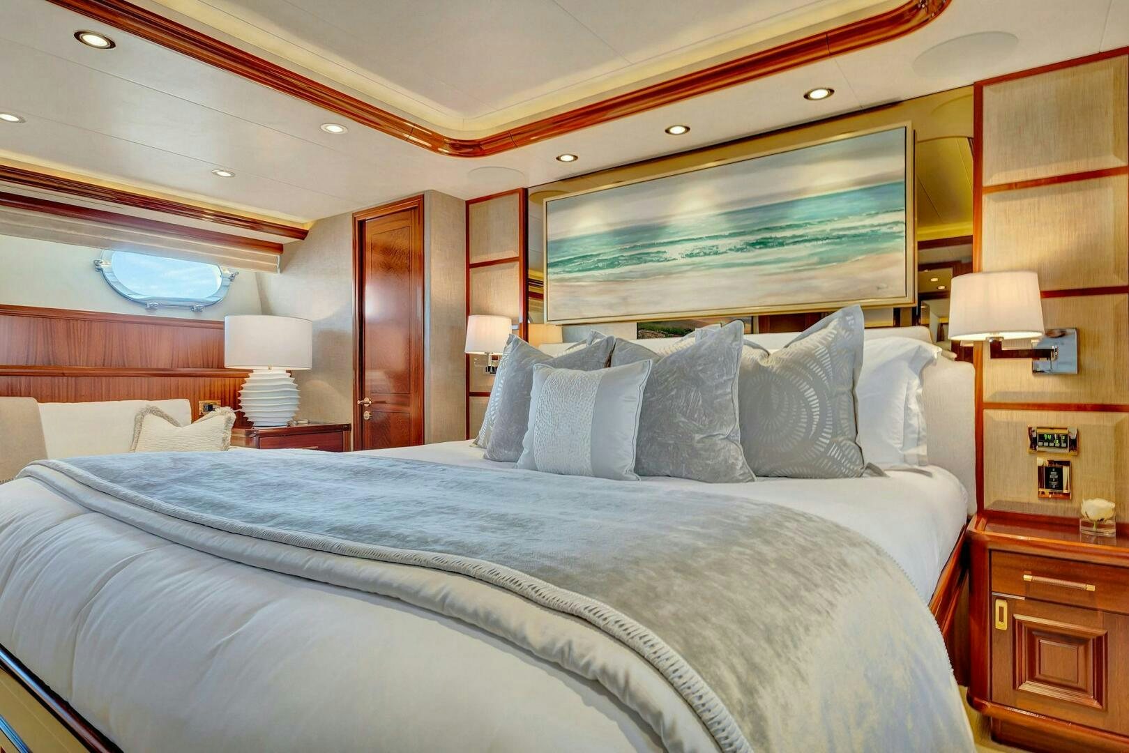 a bed with pillows and a lamp aboard JEANNIETINI NAME RESERVED Yacht for Sale